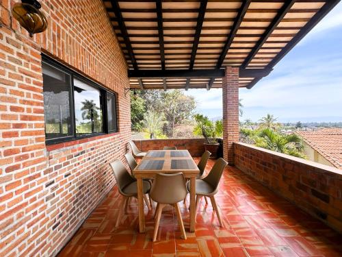 a patio with a table and chairs on a brick wall at ANANA Rancho San Rafael Pool and Lake Views in Ajijic
