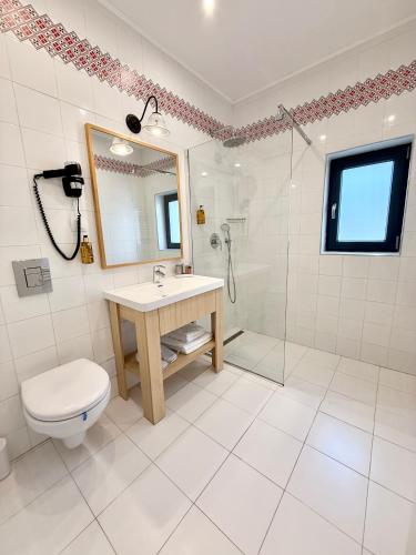 a bathroom with a toilet and a sink and a shower at Krystal Boutique Mansion in Hunedoara