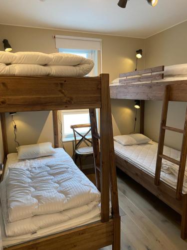 two bunk beds in a room with a window at Åre Sadeln Ski in ski out in Åre