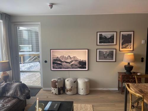 a living room with a couch and two drums at Åre Sadeln Ski in ski out in Åre