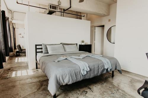 a bedroom with a large bed in a white room at The Downtown Industrial Loft in Memphis