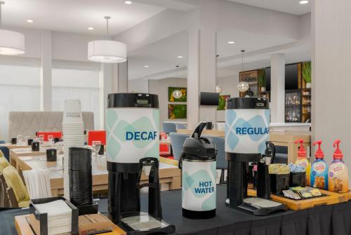 a store with two deez machines on a table at Hilton Garden Inn Dover in Dover