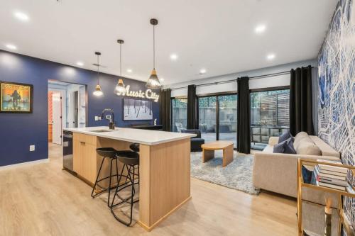 a kitchen with a bar and a living room at Welcome to The Skyline Condo in Nashville