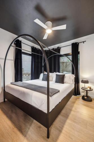 a bedroom with a bed with a ceiling fan at Welcome to The Skyline Condo in Nashville