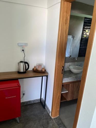 a bathroom with a sink and a counter with a sink at Refúgio By Bellatrix Ecolodge in Mata de Sao Joao