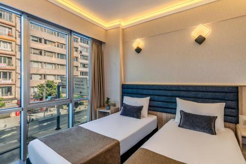 a hotel room with two beds and a window at Felix Hotel in Istanbul