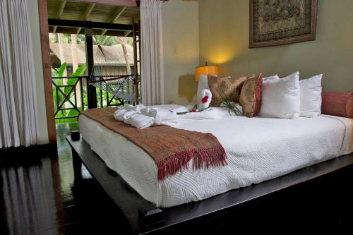 a bedroom with a large bed with a stuffed animal on it at Sunset at the Palms Resort - Adults Only - All Inclusive in Negril