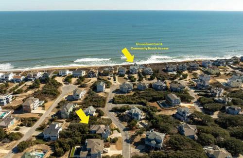an aerial view of a beach with houses and the ocean at Downtown Duck Resort Perks Ocean Views & Hot Tub in Duck