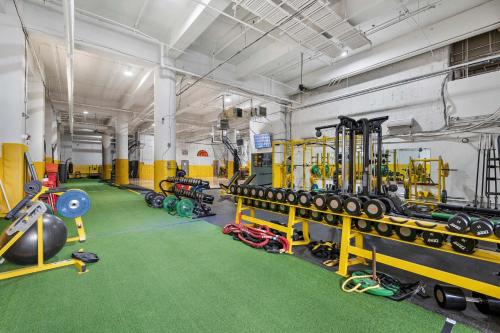 a gym with a bunch of equipment in it at New Loft 3 min to CMU Pitt Sleeps 4 in Pittsburgh