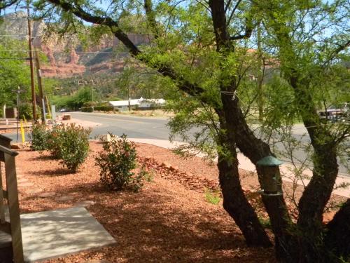 a tree next to a road with a mountain in the background at Whispering Creek Bed & Breakfast in Sedona