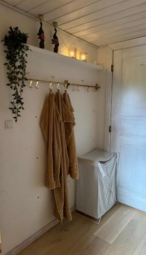 a room with coats hanging on a wall at Villa Malena in Fensmark