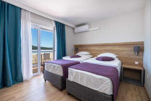 Postel nebo postele na pokoji v ubytování Hotel Porat