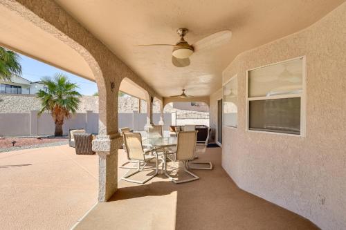 a patio with a table and chairs and a ceiling fan at Lake Havasu Home - 2 Mi from Main Launch Ramp! in Lake Havasu City
