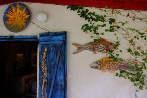 two fish on the side of a wall with a mirror at Chata pod Żurawiem 