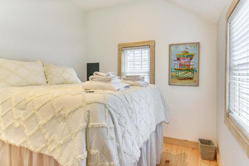 a bedroom with a bed with towels on it at Walk to Shops and Dining Cozy Osterville Cottage in Osterville