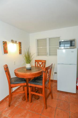 a kitchen with a table and chairs and a refrigerator at Villa Sessions Entire House in Isabela