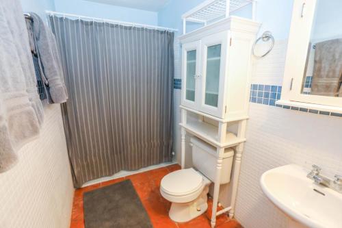 a bathroom with a toilet and a sink and a shower at Villa Sessions Entire House in Isabela