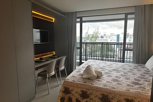 Una cama o camas en una habitación de Flat a 50 metros da praia + piscina e área gourmet