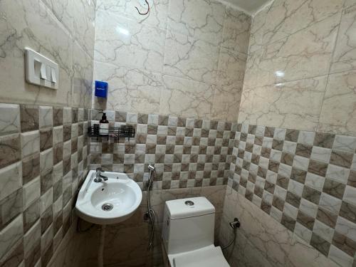 a bathroom with a white toilet and a sink at Landour Apartment Beauty and Charm Kothri- Vintage Vibes in Mussoorie