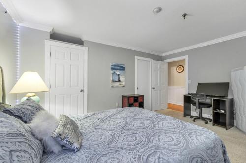 a bedroom with a large bed and a desk at Lakeview Escape, Pool, Fast Wi-Fi & Free Parking in Laconia