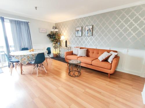 a living room with a couch and a table at Lakeview Escape, Pool, Fast Wi-Fi & Free Parking in Laconia