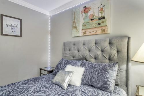 a bedroom with a gray bed with a white pillow at Lakeview Escape, Pool, Fast Wi-Fi & Free Parking in Laconia