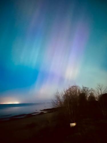 a rainbow in the sky over a beach at SMART flat - Ranna 49 in Sillamäe