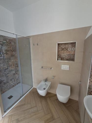 a bathroom with a shower and a toilet and a sink at Residenza Rivellini Tropea in Tropea