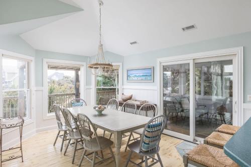 a dining room with a table and chairs at New Listing Semi Ocean Front with Pool & Hot Tub in Duck
