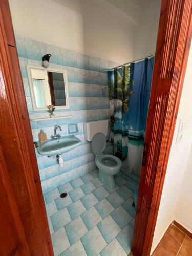 a bathroom with a toilet and a sink at Aris Paschalia Studios in Argyrádes