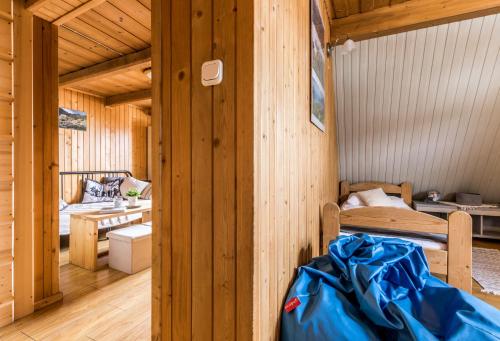 a wooden cabin with a bed and a desk at Apartament Kalina-Mocarni in Kościelisko