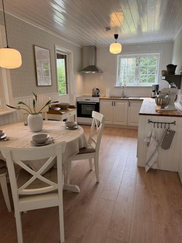 a kitchen with a table and chairs in a room at Hus Björklund in Hällefors
