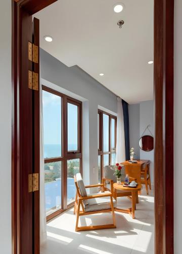 a living room with a chair and a table at Stellar Hotel Phú Quốc in Phu Quoc