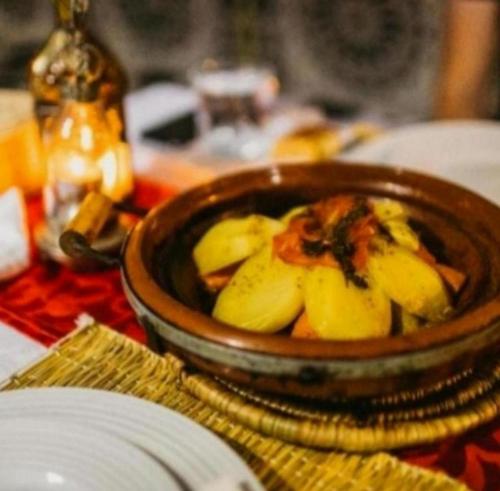 a bowl of food on top of a table at Riad Dar Maria in Merzouga
