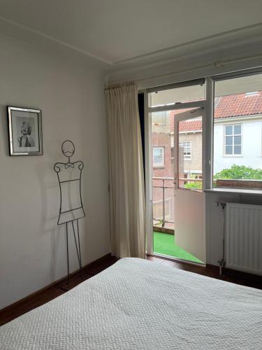 a bedroom with a mannequin in front of a window at Franciscus in Bergen op Zoom
