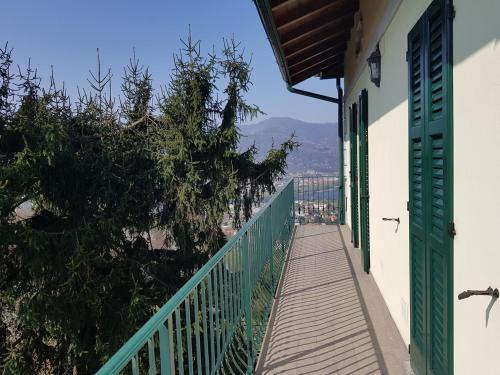a balcony with a wooden walkway next to a building at Il Palazzo apartment with a view of the lake and nature in Calolziocorte