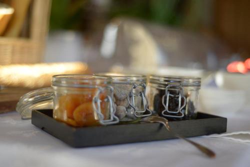 three glass jars sitting on top of a table at Logis Hotel Restaurant Au Boeuf Rouge in Niederschaeffolsheim