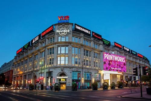 a large building on the corner of a street at Manchester City Centre Apt with Balcony & Free Parking in Manchester