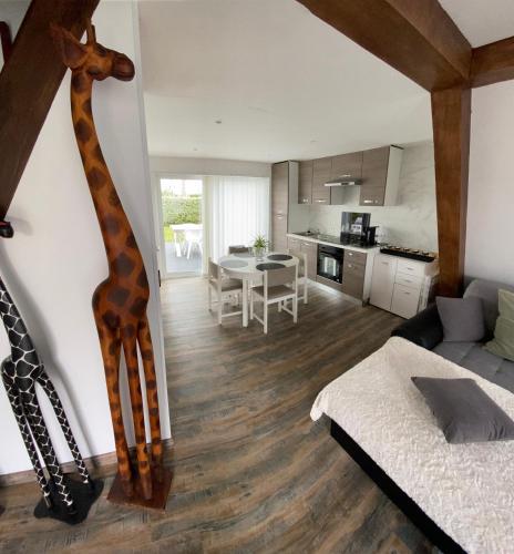 a living room with a giraffe on the wall at Dune & zee in Oostduinkerke