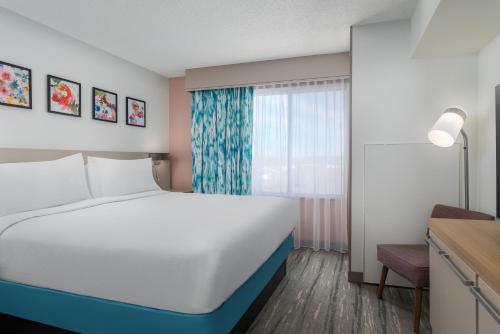 a bedroom with a white bed and a window at Hilton Garden Inn Dover in Dover