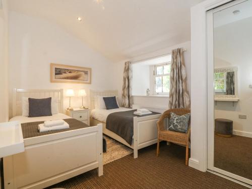 a bedroom with two beds and a window at Maritime Mews, 6 The Oakleys in Porthmadog