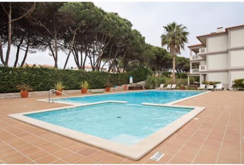 a large swimming pool next to a building at Good vibes in Amoreira