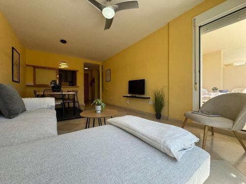 a bedroom with two beds and a living room at Sunset Beach Front in Almerimar