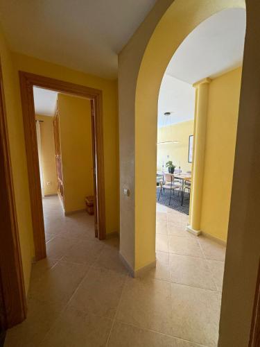an empty hallway with yellow walls and a dining room at Sunset Beach Front in Almerimar