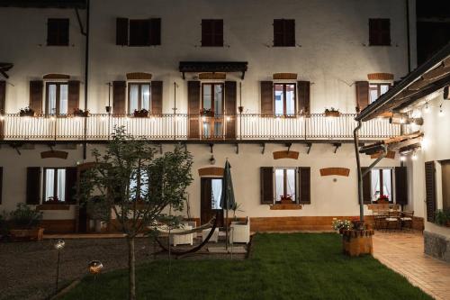 a large building with a yard in front of it at Casa Pierre in Castelnuovo Bormida