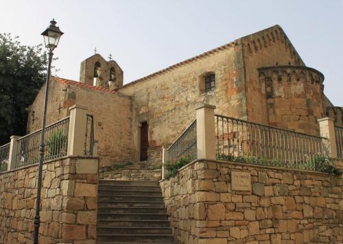an old stone building with stairs and a street light at DiamanteSardo camera e bagno privato in Villamar