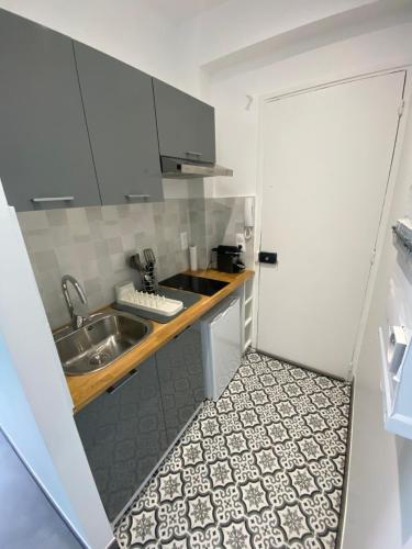 a small kitchen with a sink and a counter at Studio à cote du parc des expositions porte de Versailles, proche metro in Vanves