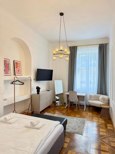 a bedroom with a bed and a living room at Vintage Rooms in Przemyśl