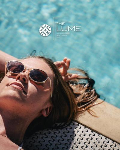 a man and a woman laying in a swimming pool at The Lume Boutique Hotel & Restaurant & Spa in Bodrum City