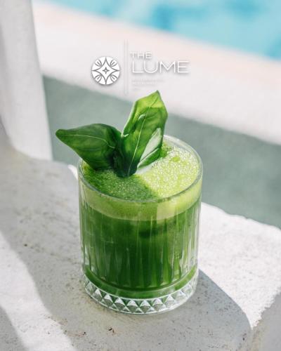 a green drink with a leaf on top of it at The Lume Boutique Hotel & Restaurant & Spa in Bodrum City